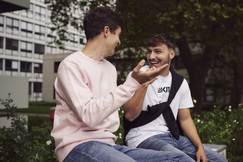 Zwei Studenten sitzen und lachen